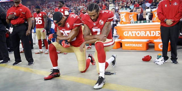FILE - In this Sept. 12, 2016, file photo, Salama Eric Reed (35) and quarterback Colin Kaepernick (7) kneel during the national anthem before an NFL football game against the Los Angeles Rams in Santa Clara, California.  When Colin Kaepernick got on his knees during the national anthem to take a stand against police brutality, racial injustice and social inequality, he was discredited by people who saw it as a crime against the state, the flag, and the military.  After nearly four years, it seems more people are starting to support Kaepernick's peaceful protest and are now calling out those who don't understand the intent of his work.