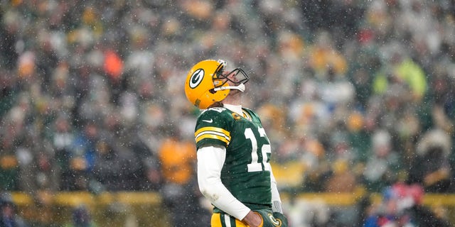 12th quarterback Aaron Rodgers of the Green Bay Packers looks up at the sky during the fourth quarter of an NFC playoff game against the San Francisco 49ers at Lambeau Field on January 22, 2022 in Green Bay, Wisconsin. 