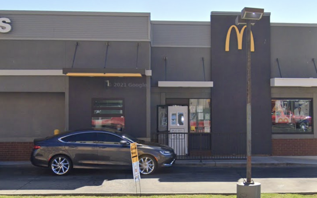 A woman was attacked and dragged in front of her children in a McDonald's car