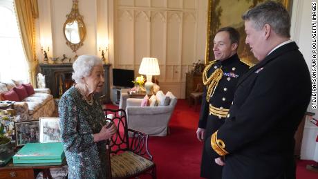 Queen Elizabeth II speaks with Admiral James MacLeod and Major General Eldon Millar (right) in the Oak Room at Windsor Castle on February 16. 