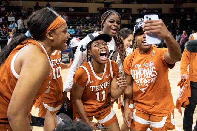 Texas Longhorns guard Joan Allen Taylor (11) and her teammates celebrate defeating the Baylor Lady Bears at City Hall.