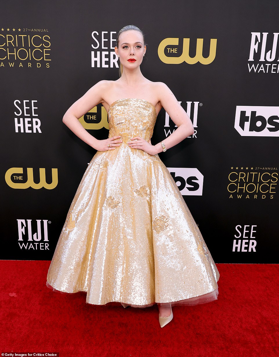 Princess: Elle Fanning looked gorgeous in a gold strapless gown with a voluminous skirt