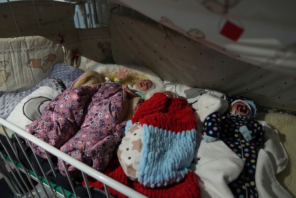 Premature babies left by their parents lie in a bed at a hospital in Mariupol on March 15, 2022.