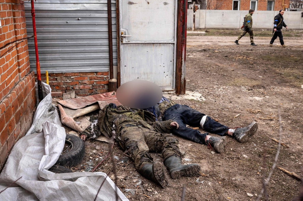 Bodies of Russian soldiers lie on the ground after Ukrainian forces recaptured the village of Mala Rogan, east of Kharkiv.