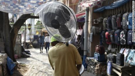 A man holds a fan during a heat wave in Kolkata, India.