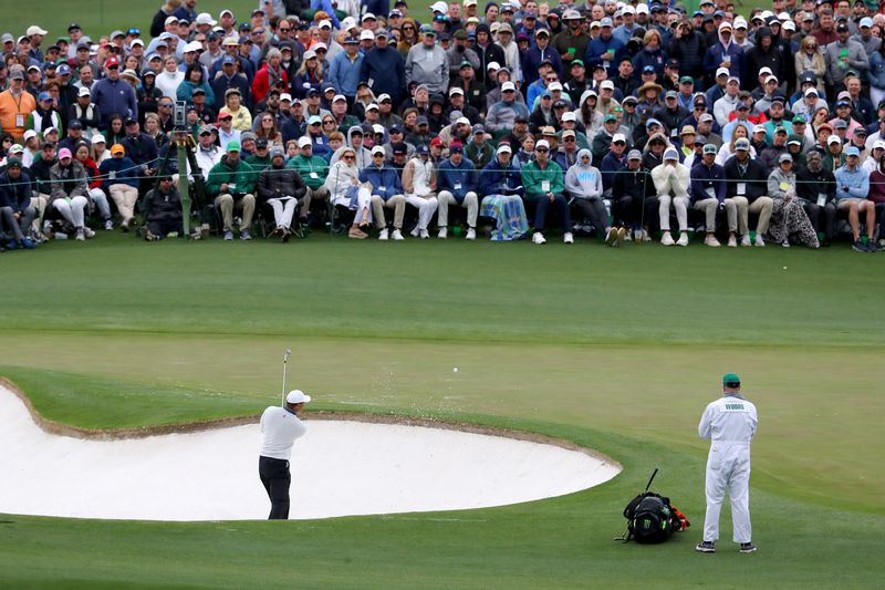 Tiger Woods hits from a bunker in the second green during the third round of the Masters Tournament at Augusta National Golf Club on Saturday, April 9, 2022 in Augusta.  (Curtis Compton / Curtis.Compton@ajc.com)