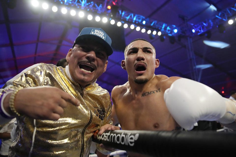 Teofimo Lopez, right, celebrates with his father Teofemo Lopez Sr. after defeating Pedro Campa by TKO in a junior boxing match, Saturday, August 13, 2022, in Las Vegas.  (AP Photo/John Locher)