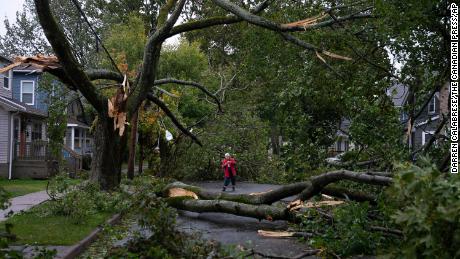 Georgina Scott surveys the damage to her street in Halifax on Saturday, September 24, 2022.  