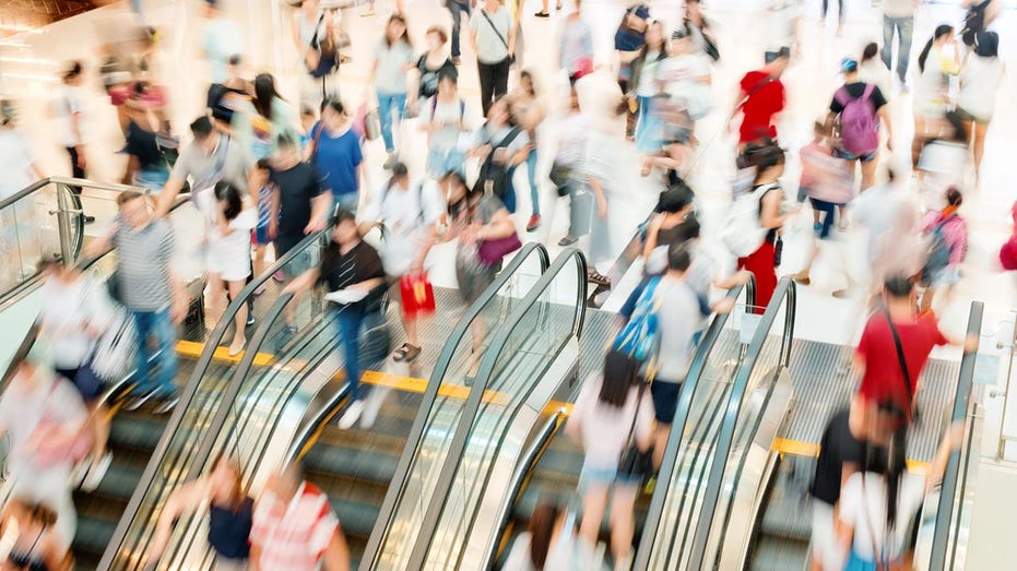 Shoppers on escalators 