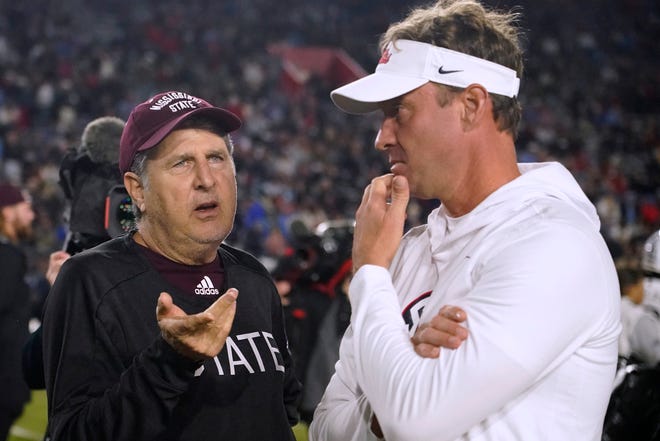 Mississippi State coach Mike Leach, left, speaks with Mississippi State coach Lane Kiffin before the NCAA college football game in Oxford on Thursday, November 24.