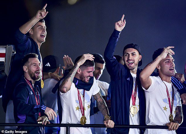 Lionel Messi and teammates Rodrigo de Paul, Leandro Paredes, Lautaro Martinez and Julian Alvarez celebrated on the open-top bus in Buenos Aires on Tuesday.